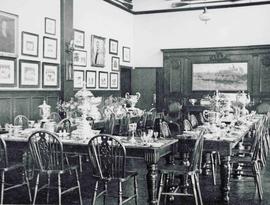 Big Room prepared for a celebratory dinner, with trophies