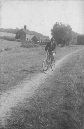 Coach cycling the towpath at Henley